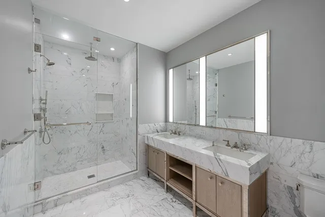 a bathroom with a sink double vanity and shower