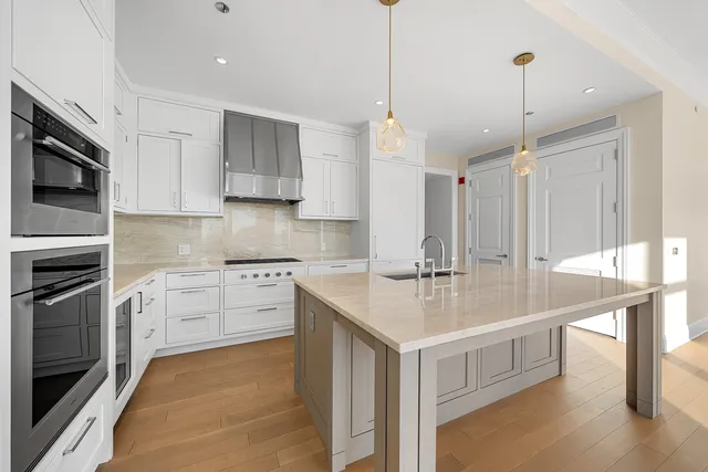 a kitchen with a sink stove and cabinets