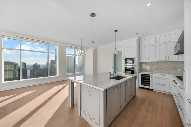 a kitchen with stainless steel appliances granite countertop a stove and a sink