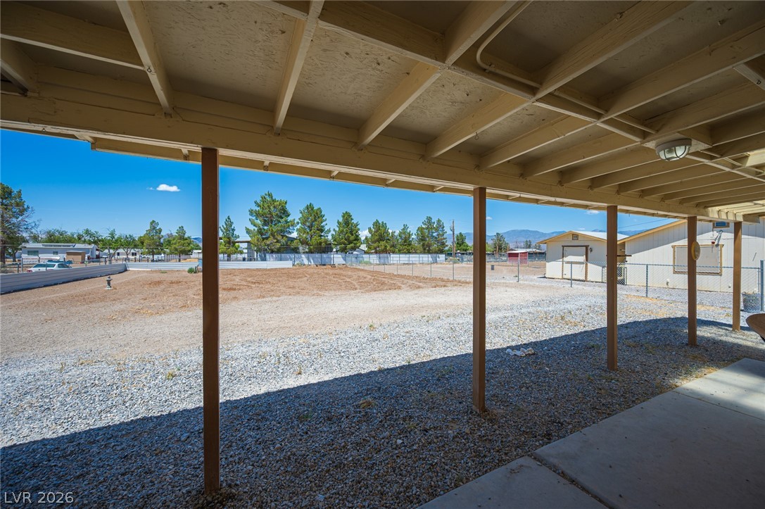 3200 Maple Road Pahrump, NV 89048 - Photo 42 of 53 A spacious covered patio offers a refreshing respite with views of the vast yard and distant mountains.