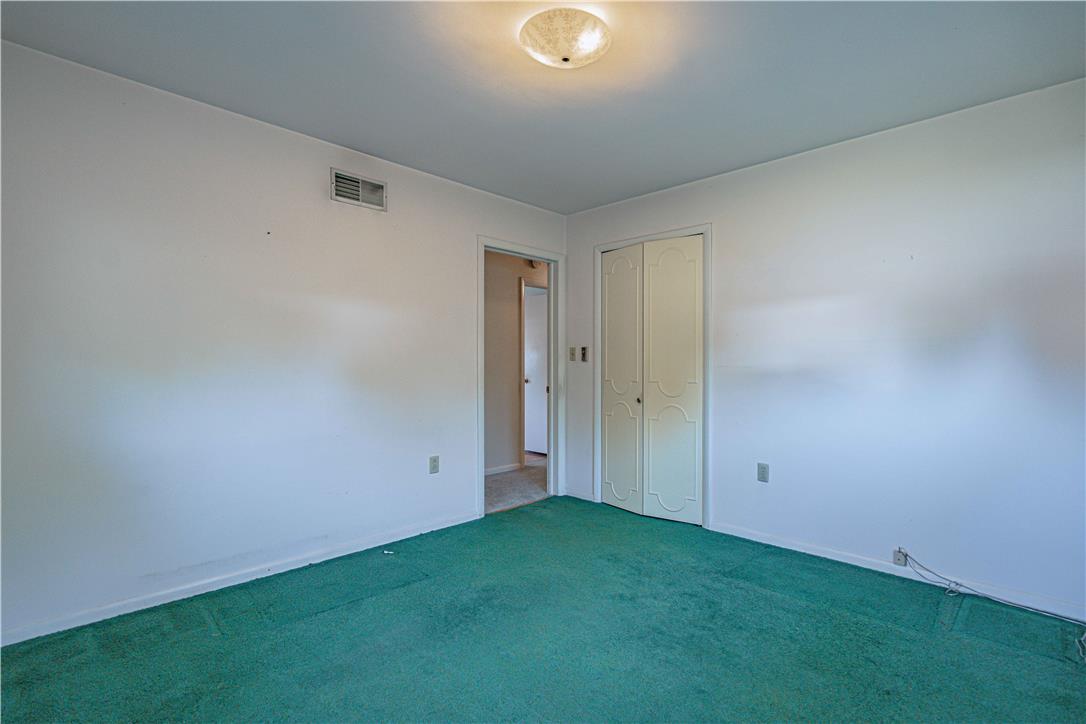 4815 Mill Road Schnecksville, PA 18078 - Photo 32 of 48 Green carpeted bedroom with bifold closet doors provides a peaceful retreat.