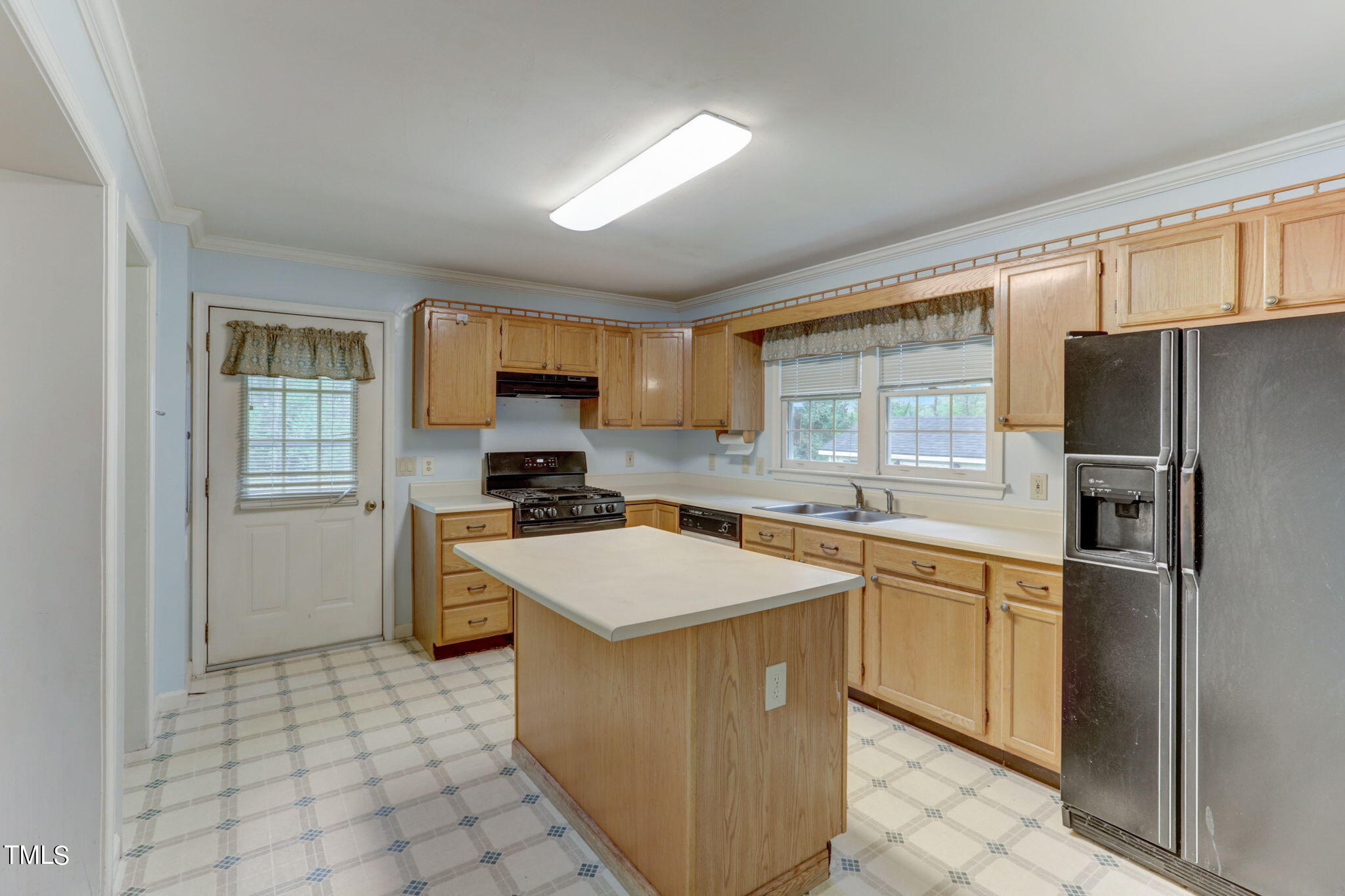 193 Lily Lane Road Roxboro, NC 27574 - Photo 13 of 45 a kitchen with stainless steel appliances granite countertop a stove top oven a sink a refrigerator and white cabinets with wooden floor