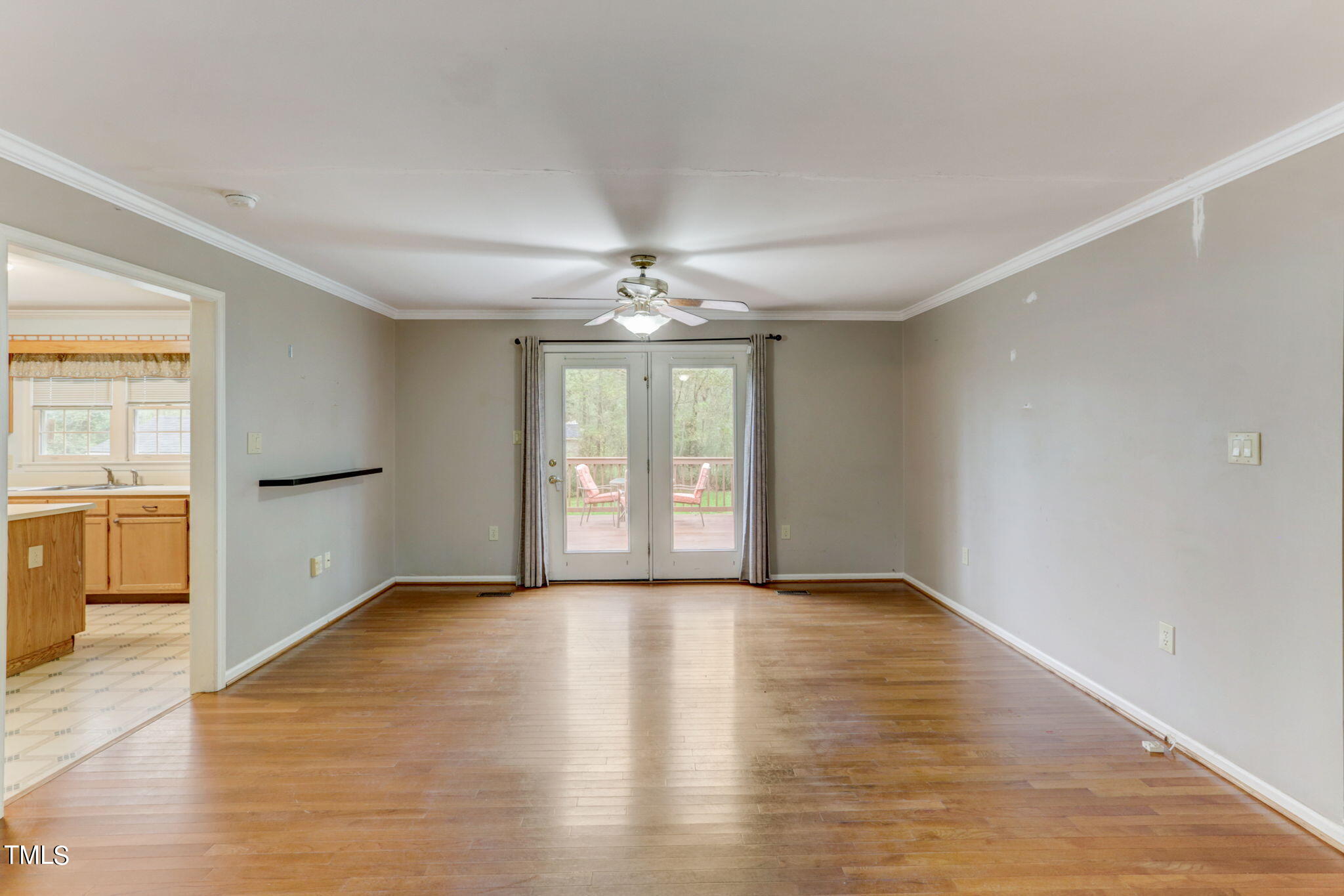 193 Lily Lane Road Roxboro, NC 27574 - Photo 16 of 45 a view of an empty room with a window and wooden floor