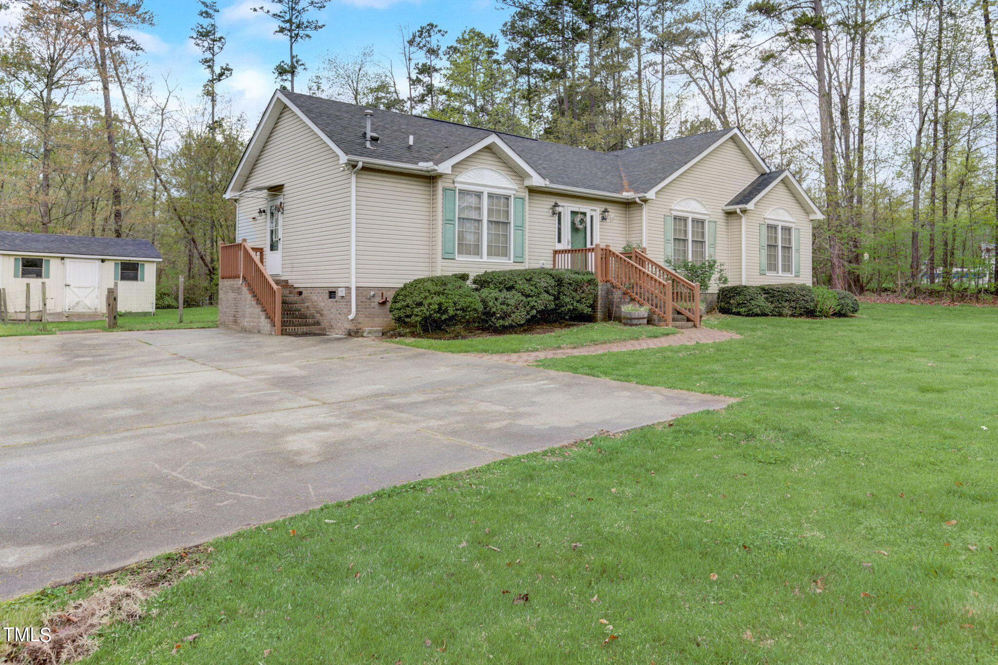193 Lily Lane Road Roxboro, NC 27574 - Photo 6 of 45 a front view of a house with a garden and trees
