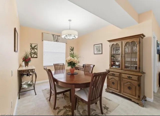 a kitchen with stainless steel appliances a table and chairs in it