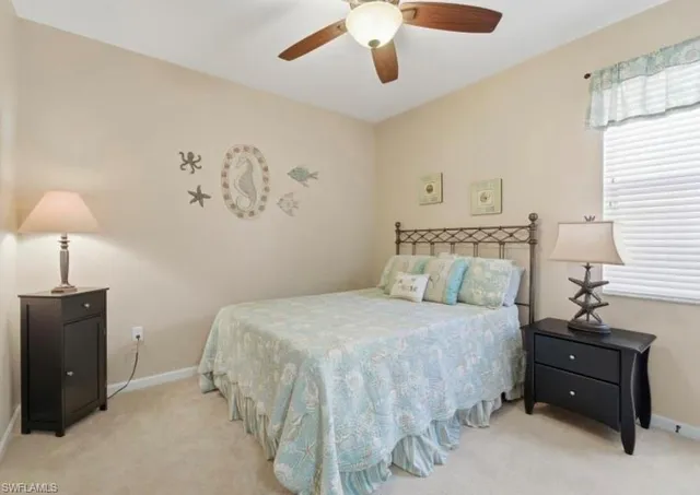 a bedroom with a bed and a table with a large window