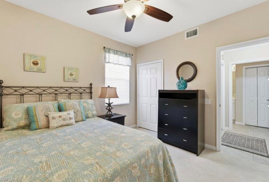 10024 Heather Lane, Unit 1001 Naples, FL 34119 - Photo 15 of 23 a bedroom with a bed and a dresser
