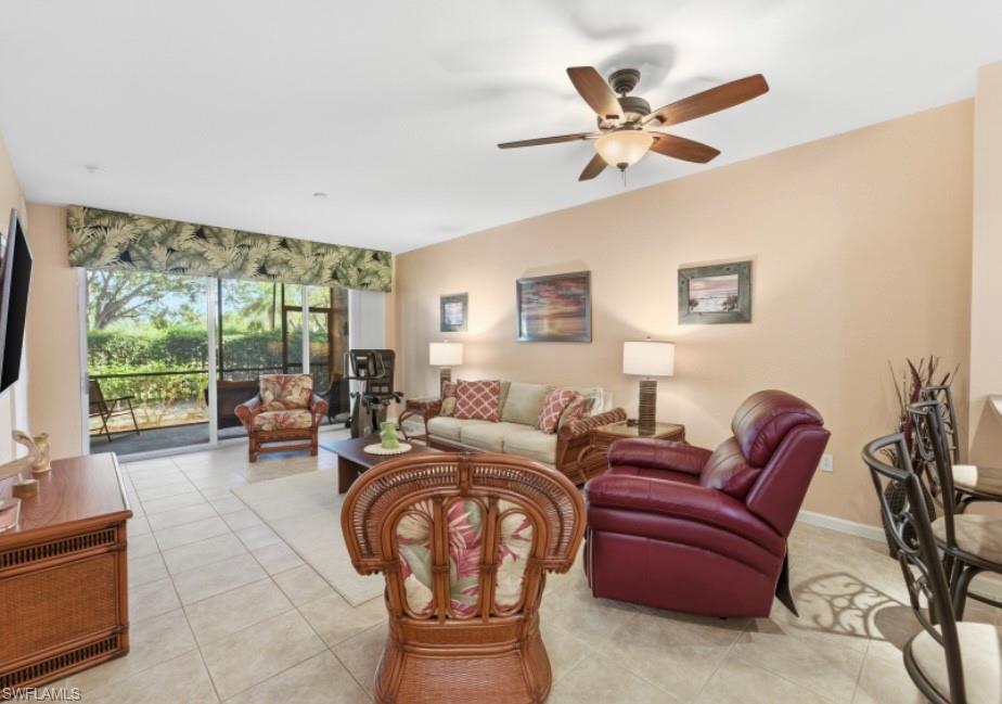 10024 Heather Lane, Unit 1001 Naples, FL 34119 - Photo 5 of 23 a living room with furniture and a large window