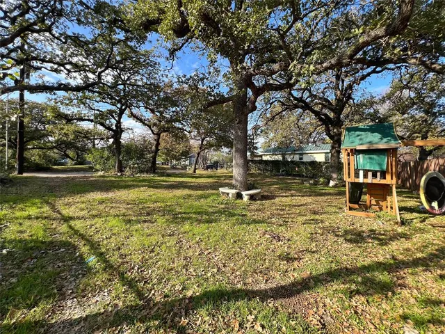 a view of yard with swimming pool and green space