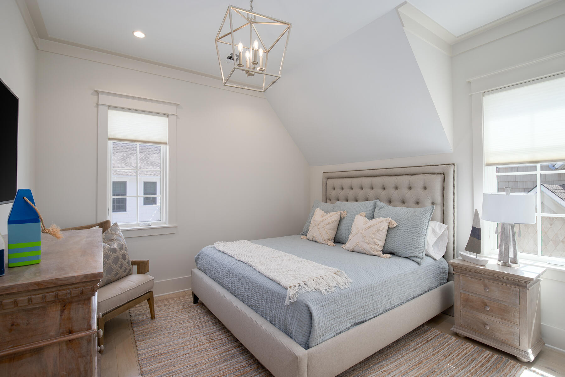 10 Rainer Lane Watersound, FL 32461 - Photo 23 of 30 a bedroom with a large bed and a chandelier