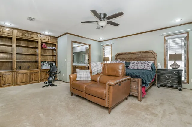 a living room with furniture and a ceiling fan