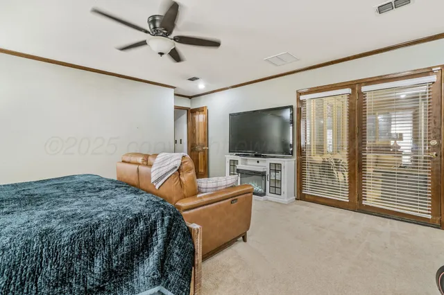 a bedroom with furniture and a flat screen tv
