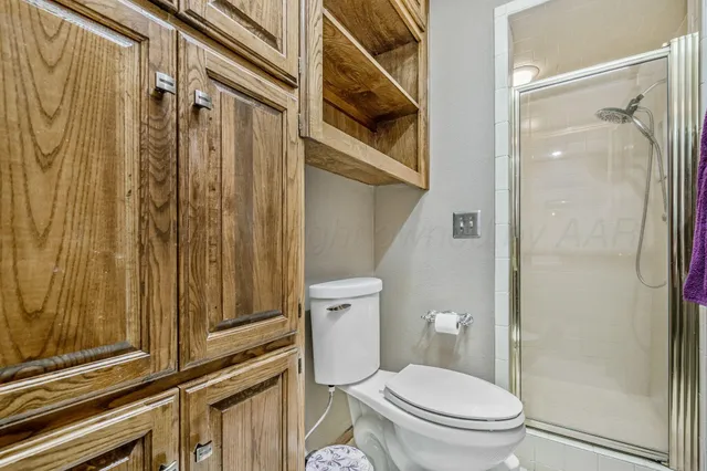 a white toilet sitting next to a bathroom