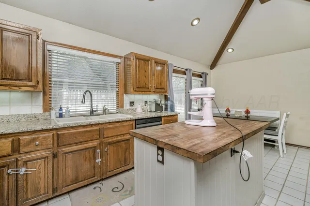 a kitchen that has a table and chairs in it