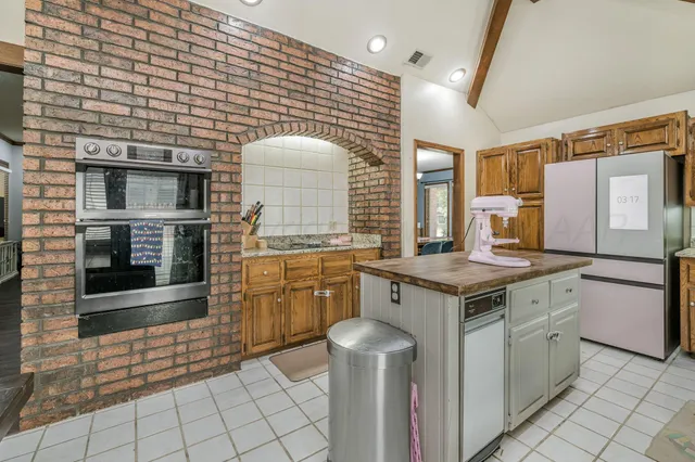 a kitchen with a stove a sink and a refrigerator