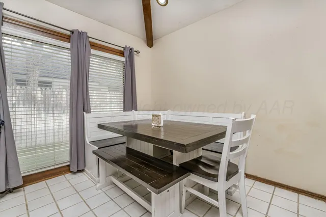 a view of a dining room with furniture and window