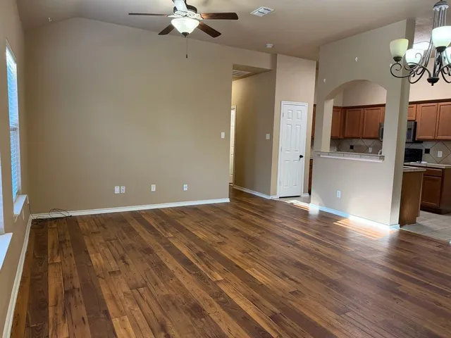 a view of a livingroom with a furniture wooden floor and a ceiling fan