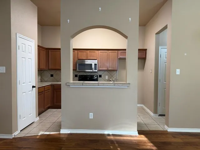 a view of a kitchen with a sink a refrigerator and window