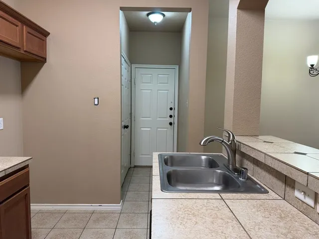 a bathroom with a tub a sink and mirror