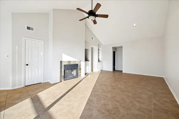 a view of a livingroom with a ceiling fan a fireplace and a ceiling fan