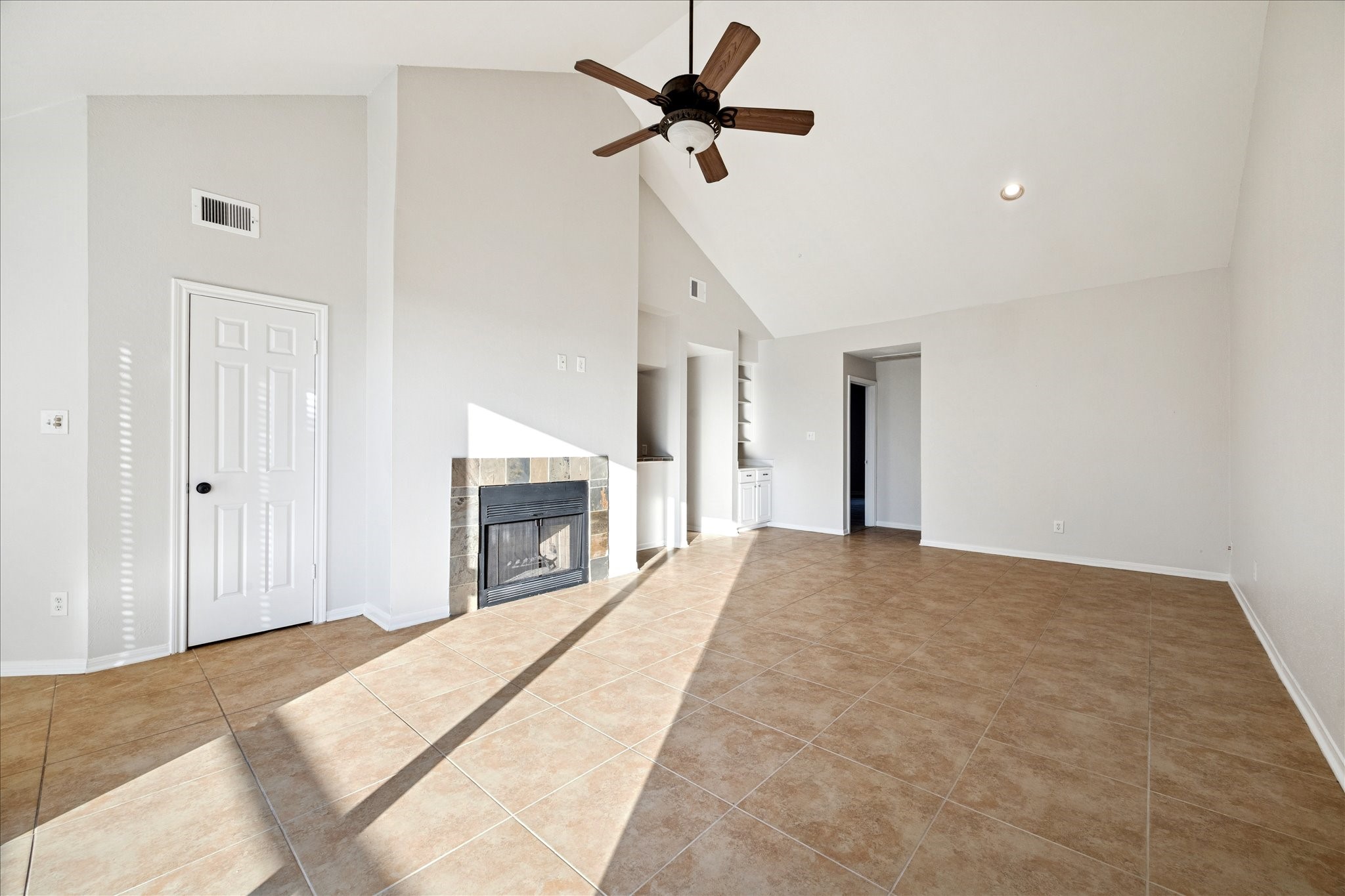 5200 Weslayan Street, Unit 302 Houston, TX 77005 - Photo 4 of 15 a view of a livingroom with a ceiling fan a fireplace and a ceiling fan