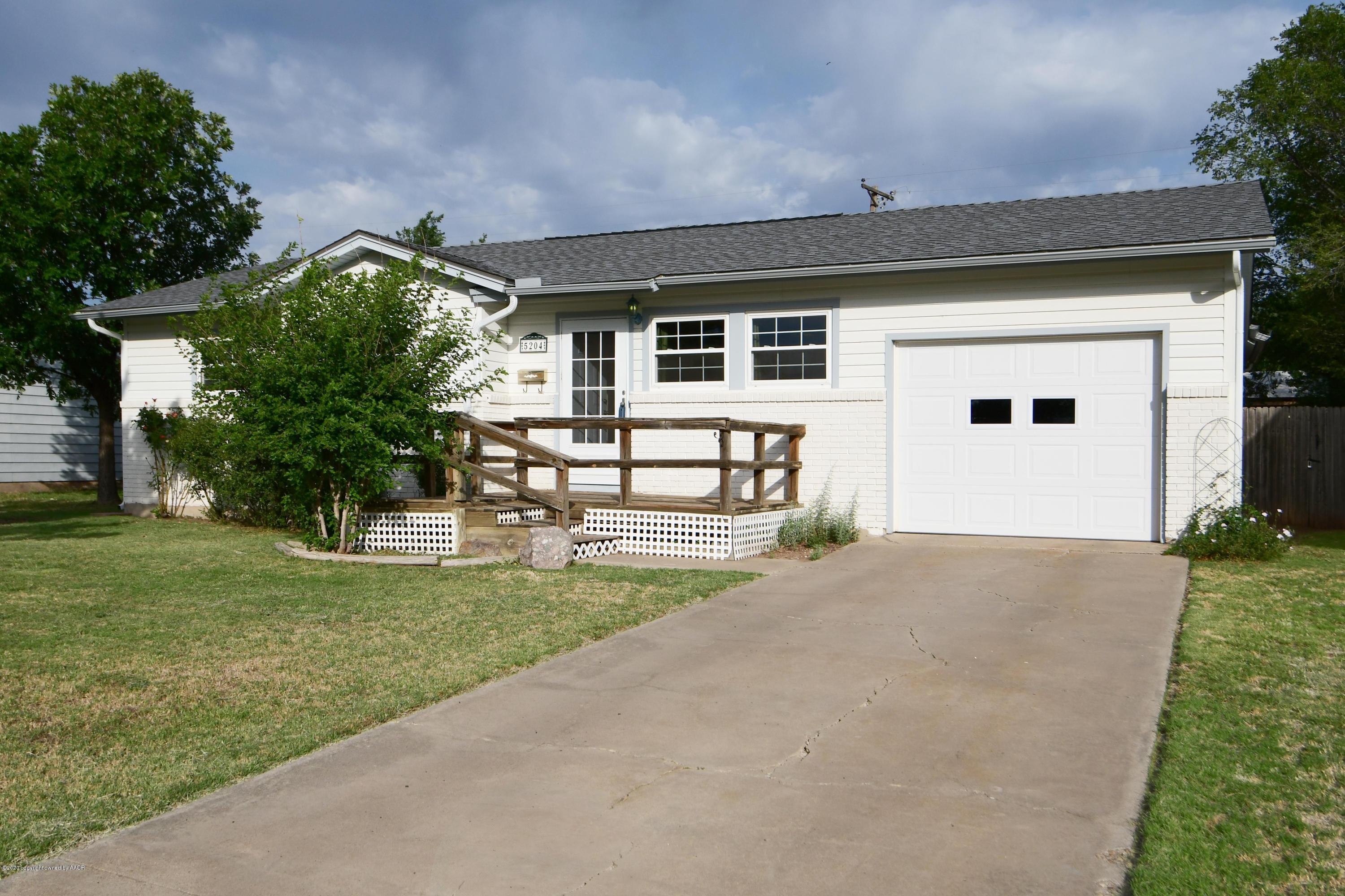 5204 South Travis Street Amarillo, TX 79110 - Photo 1 of 25 front view of a house with a yard