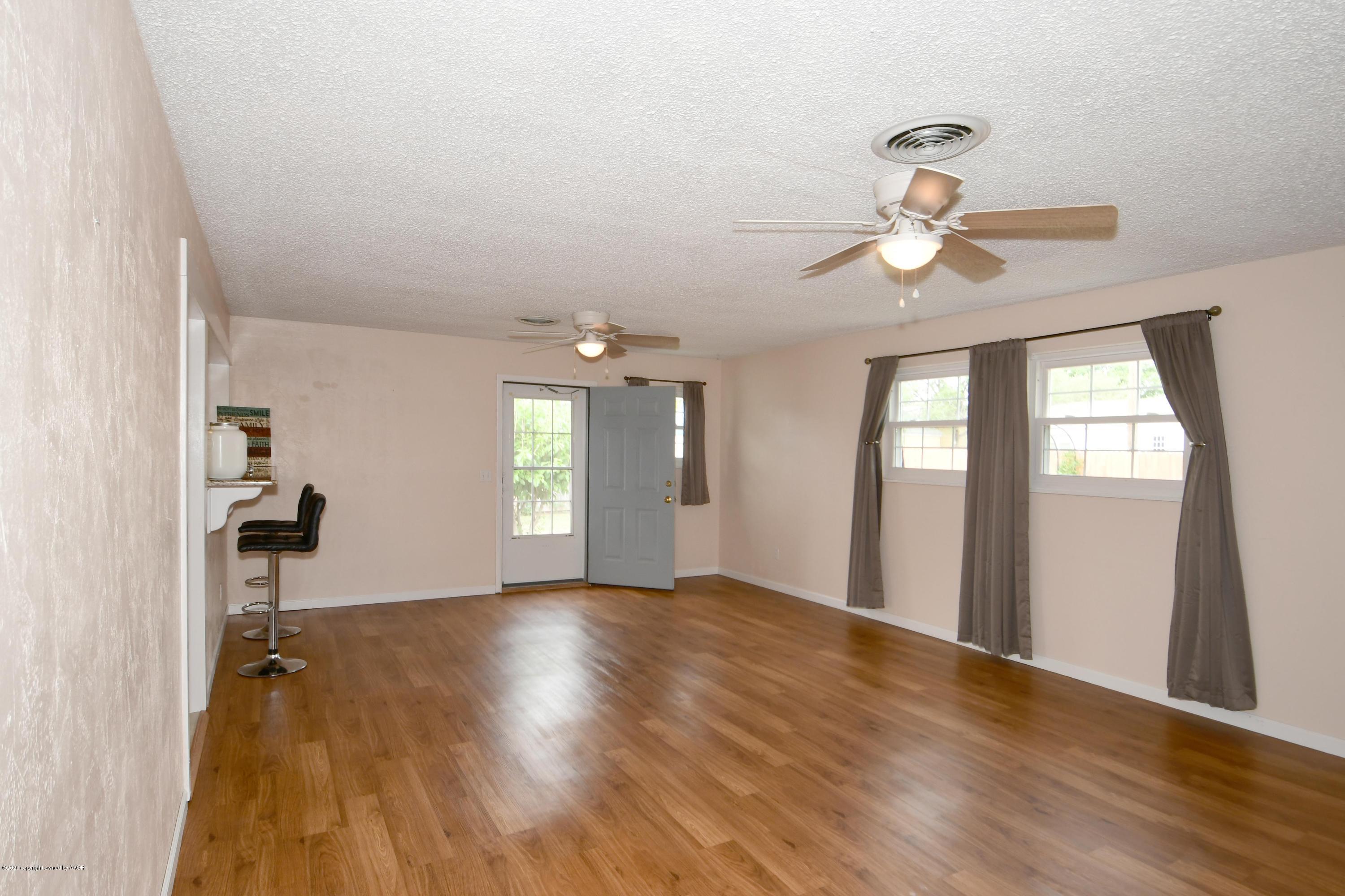 5204 South Travis Street Amarillo, TX 79110 - Photo 11 of 25 wooden floor in an empty room with a window