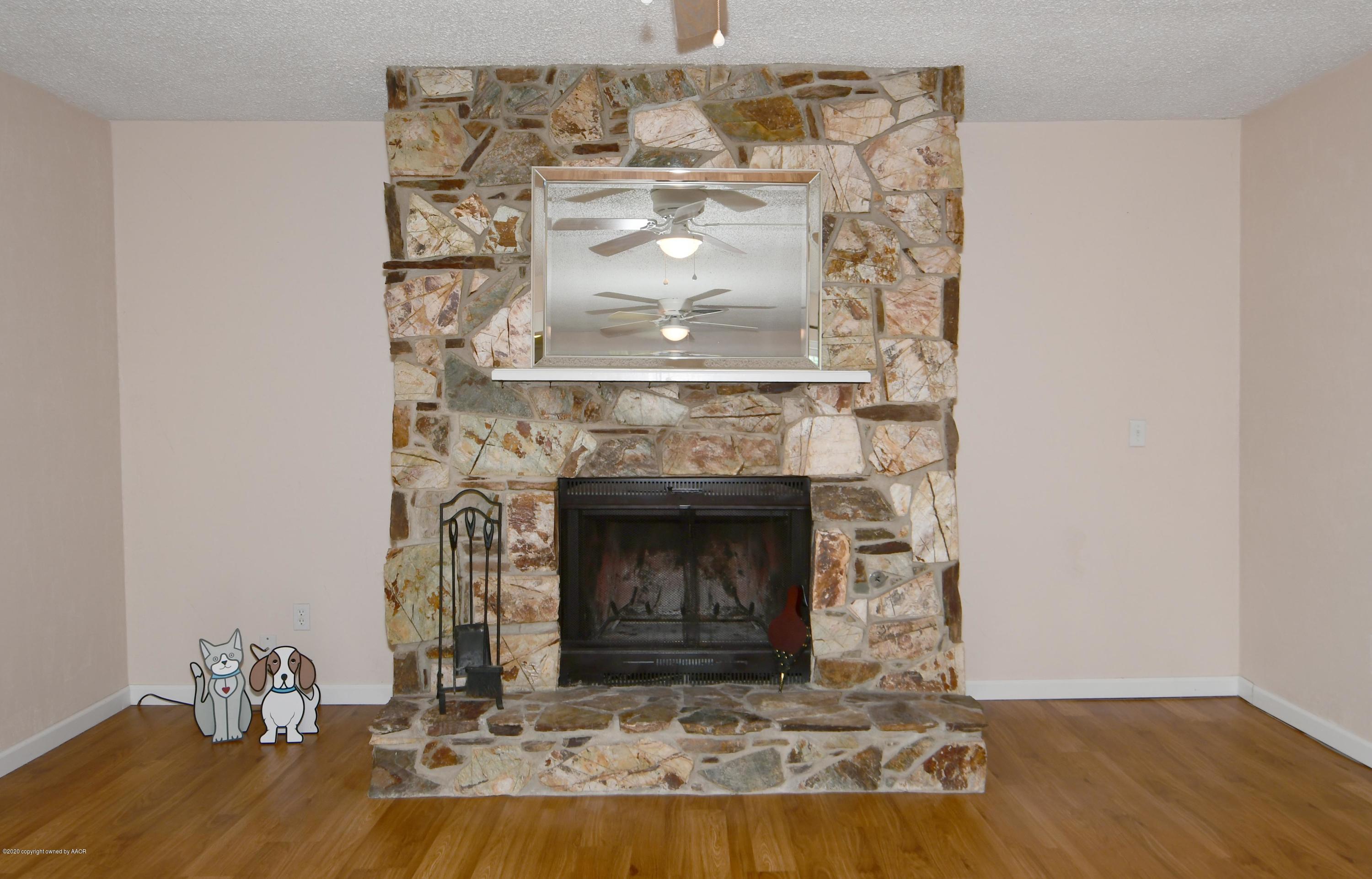 5204 South Travis Street Amarillo, TX 79110 - Photo 12 of 25 a living room with a fireplace