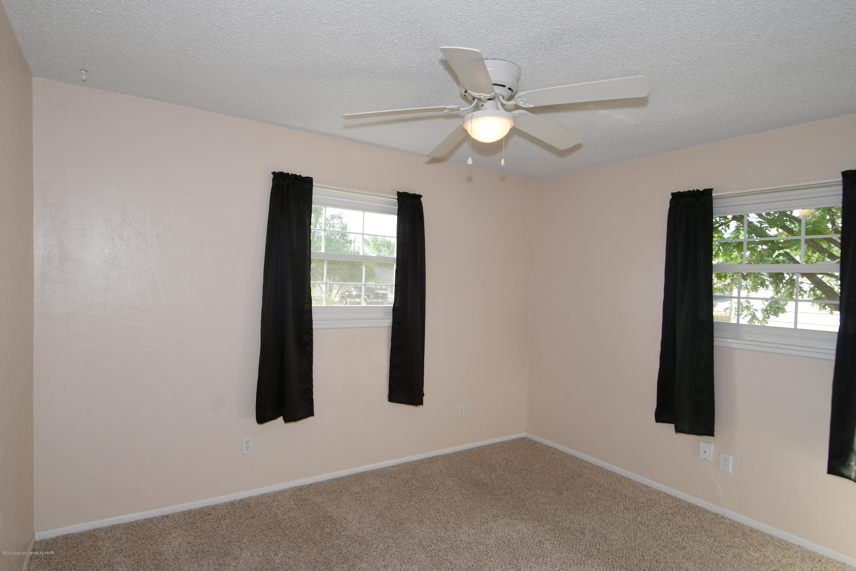 5204 South Travis Street Amarillo, TX 79110 - Photo 14 of 25 wooden floor in an empty room with a window