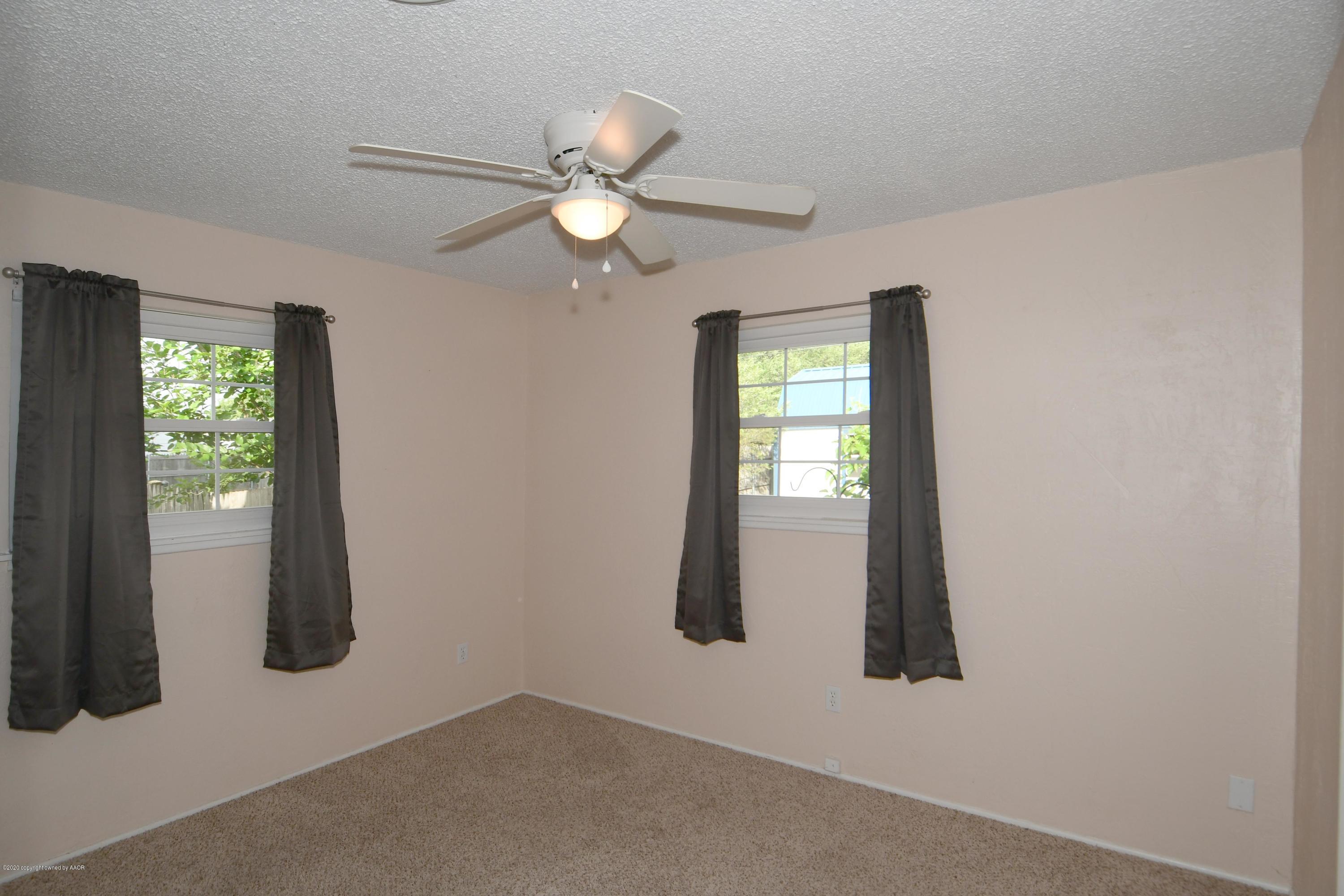 5204 South Travis Street Amarillo, TX 79110 - Photo 16 of 25 an empty room with windows and closet