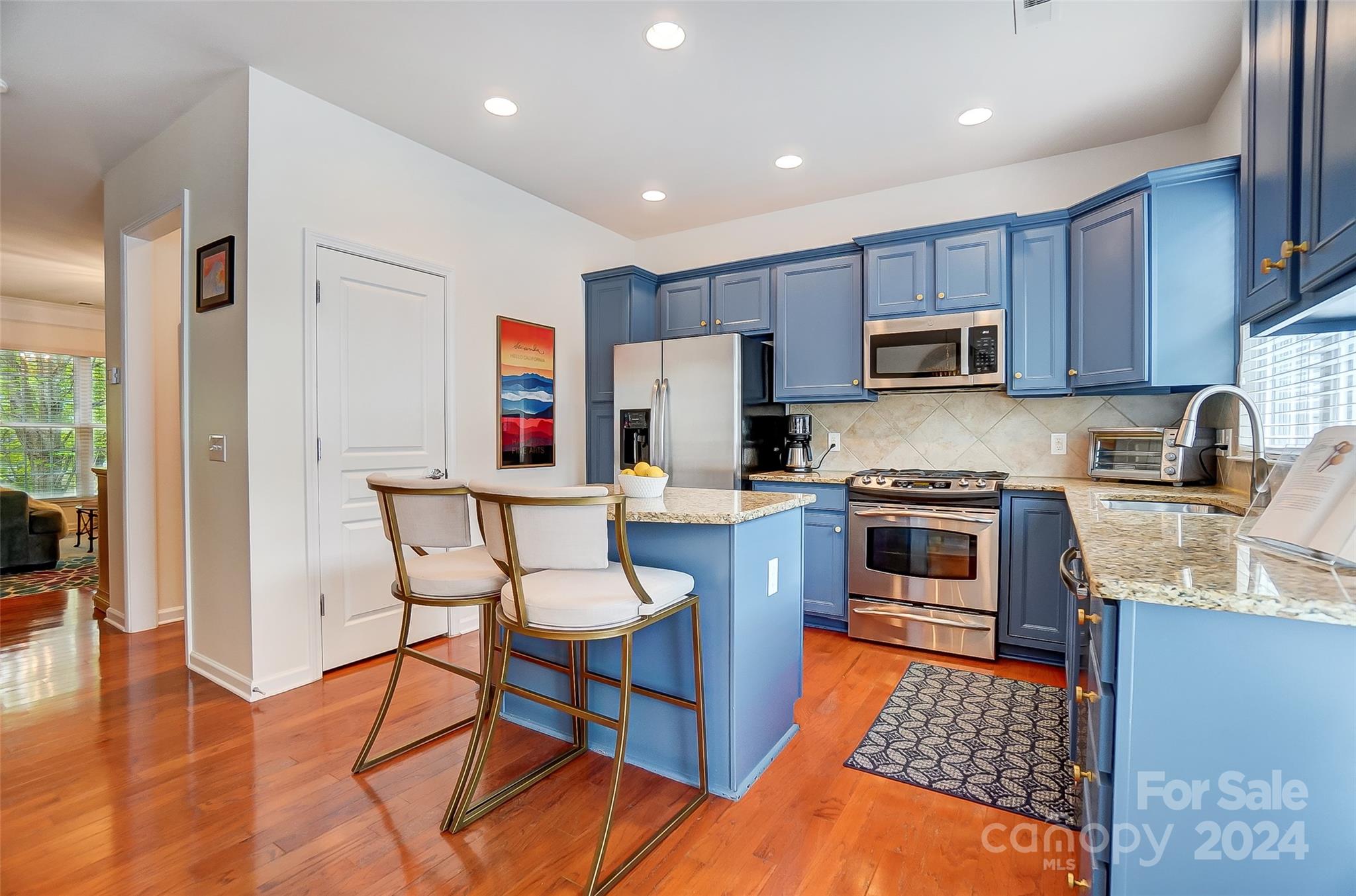 825 Granby Drive Fort Mill, SC 29708 - Photo 12 of 38 a kitchen with stainless steel appliances a stove a sink a microwave a refrigerator and cabinets