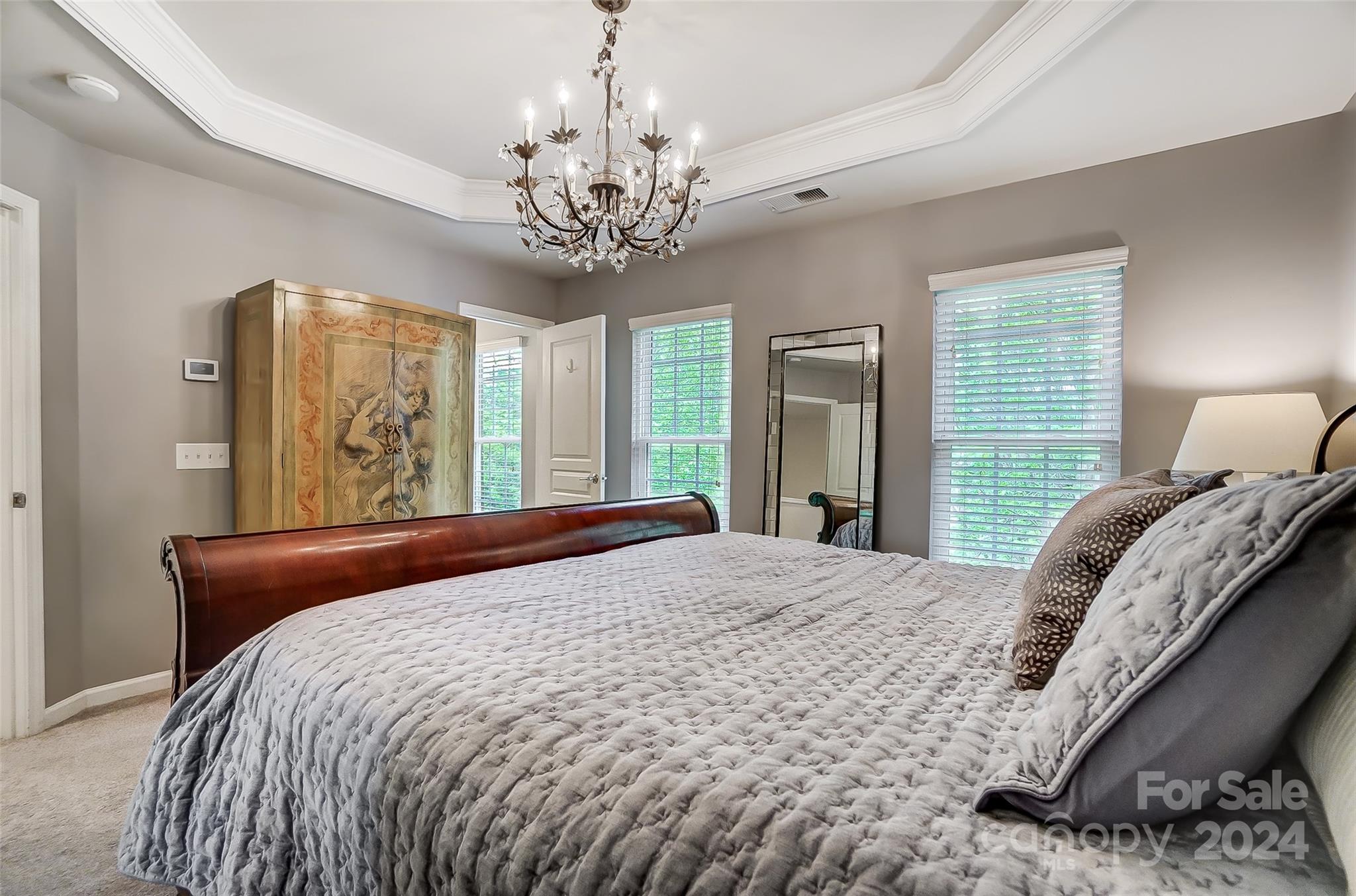 825 Granby Drive Fort Mill, SC 29708 - Photo 23 of 38 a bedroom with a large bed and a chandelier