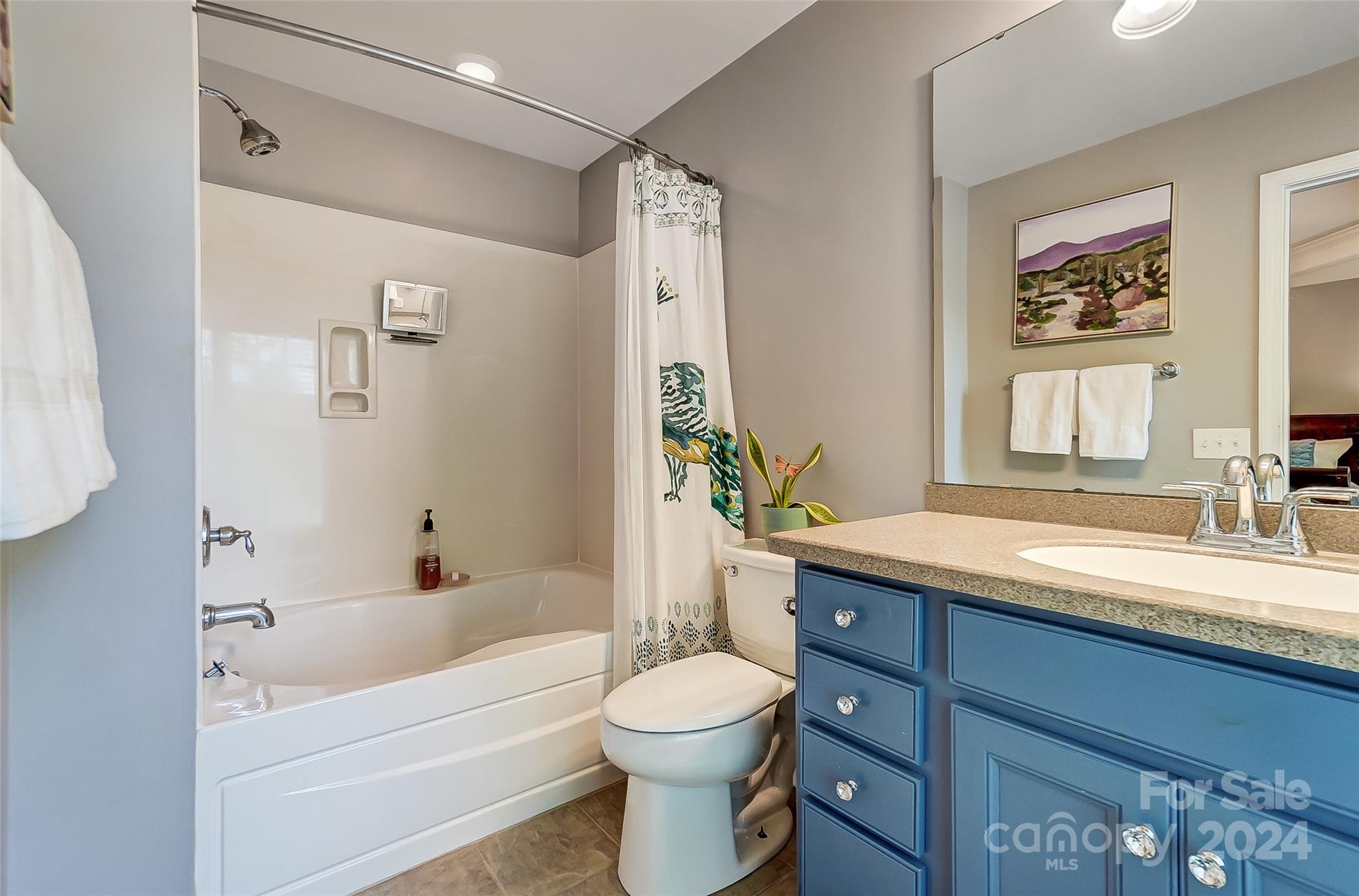 825 Granby Drive Fort Mill, SC 29708 - Photo 24 of 38 a bathroom with a granite countertop sink toilet a large mirror a bathtub and shower