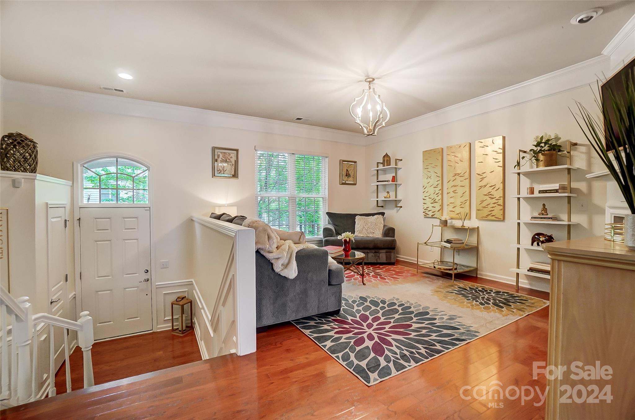 825 Granby Drive Fort Mill, SC 29708 - Photo 5 of 38 a living room with furniture and a chandelier