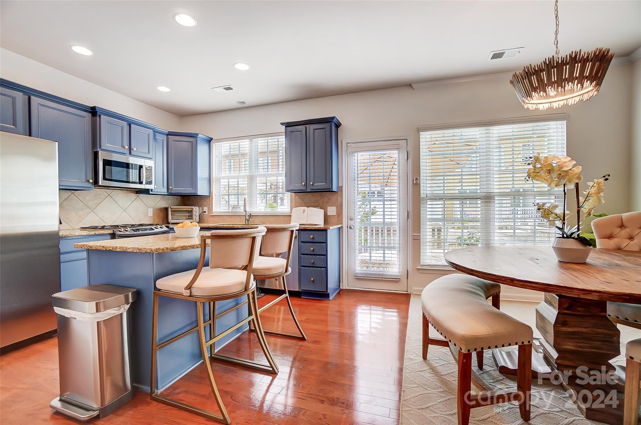 825 Granby Drive Fort Mill, SC 29708 - Photo 10 of 38 a kitchen with stainless steel appliances granite countertop a stove a sink a refrigerator dining table and chairs