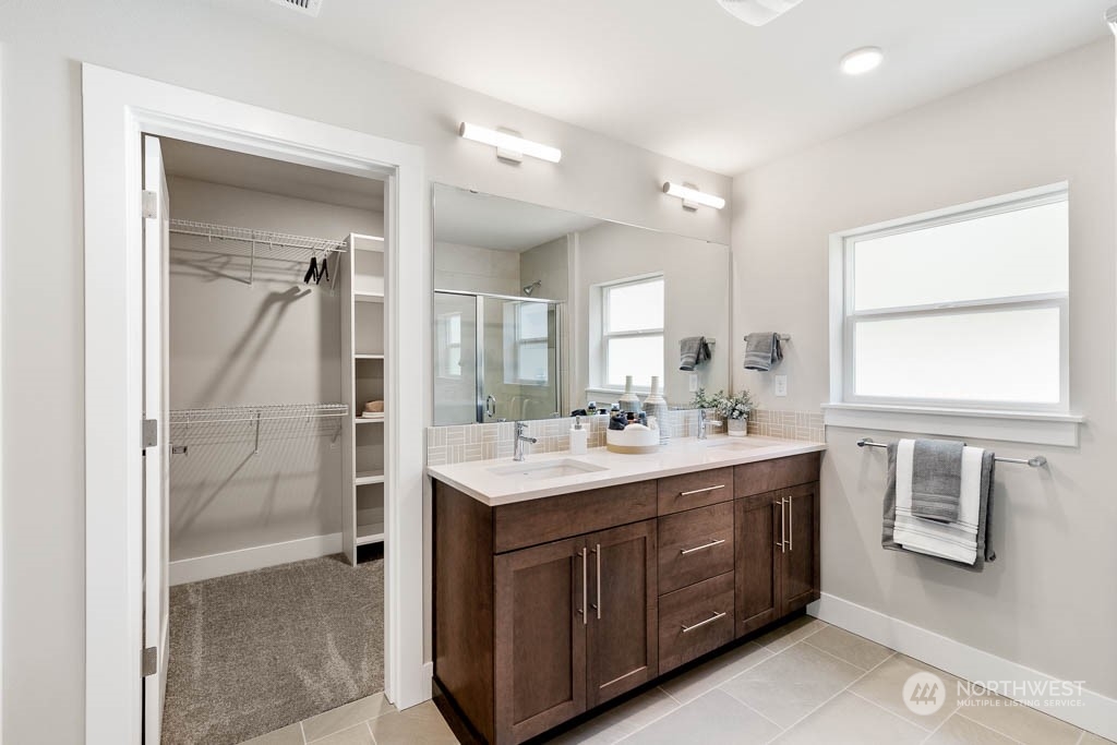 2021 228th Place Southwest, Unit EP 4 Bothell, WA 98021 - Photo 17 of 25 a bathroom with a sink a toilet a mirror and shower