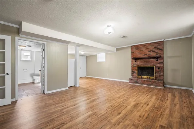 wooden floor fireplace and natural light in room