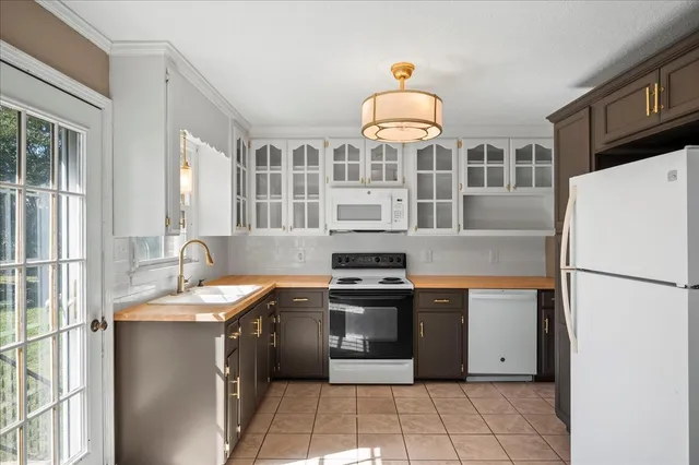 a kitchen with stainless steel appliances granite countertop a stove a refrigerator and a sink