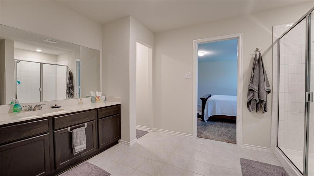 938 Corbitt Lane Fate, TX 75189 - Photo 14 of 16 a en suite bathroom with a double sink and mirror