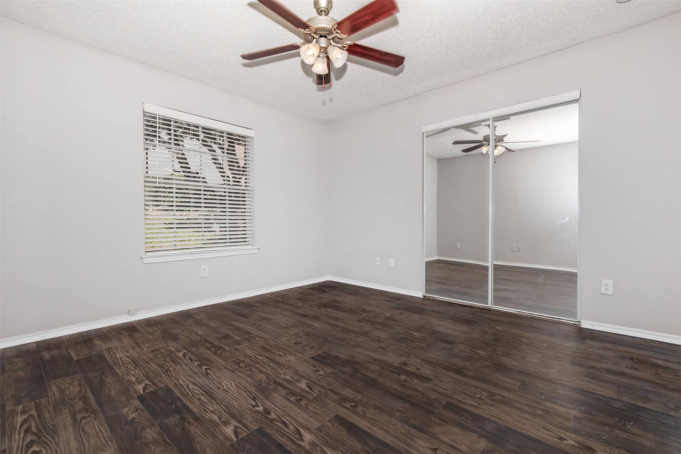 8301 Boat Club Road, Unit 312 Fort Worth, TX 76179 - Photo 8 of 44 a view of an empty room with a window and wooden floor