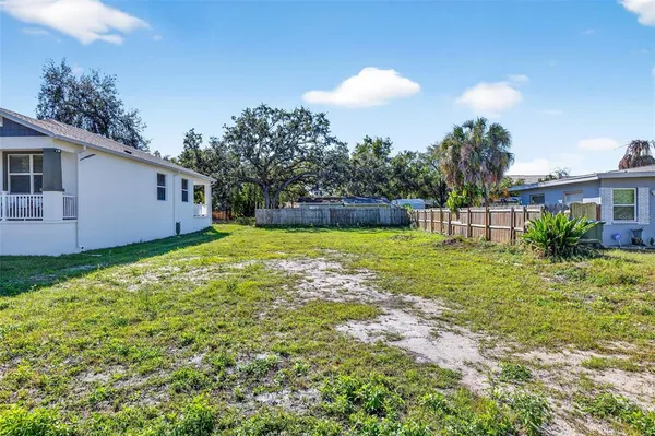 a view of a house with a backyard and a garden