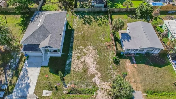 an aerial view of a house with a yard and garden
