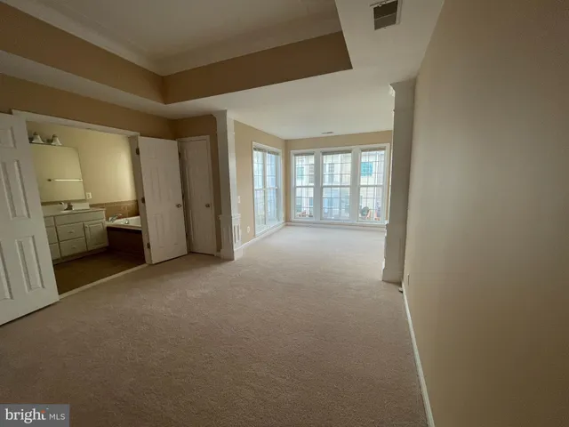 a view of empty room with furniture and window