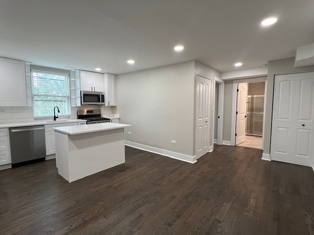 1957 West 23rd Street, Unit 3R Chicago, IL 60608 - Photo 2 of 7 a kitchen with a refrigerator and a stove top oven