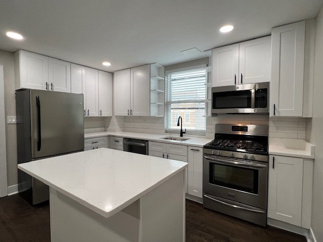 1957 West 23rd Street, Unit 3R Chicago, IL 60608 - Photo 3 of 7 a kitchen with a stove a refrigerator and a microwave