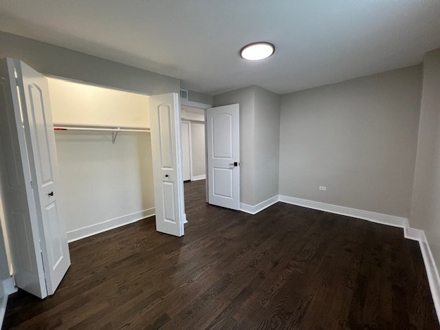 1957 West 23rd Street, Unit 3R Chicago, IL 60608 - Photo 6 of 7 an empty room with wooden floor and windows
