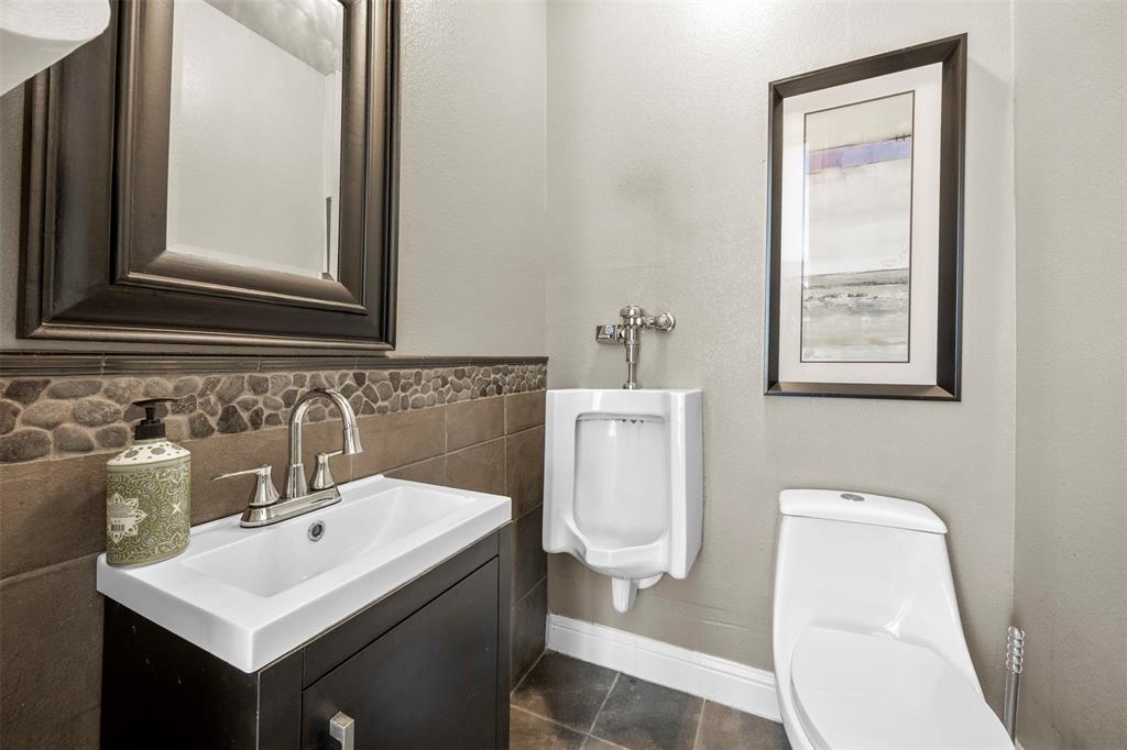 219 Mohundro Road Ferris, TX 75125 - Photo 13 of 40 a bathroom with a toilet a sink and mirror