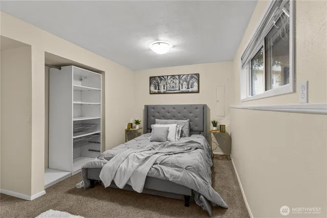 a bedroom with a bed and a window