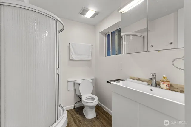 a bathroom with a toilet sink and mirror