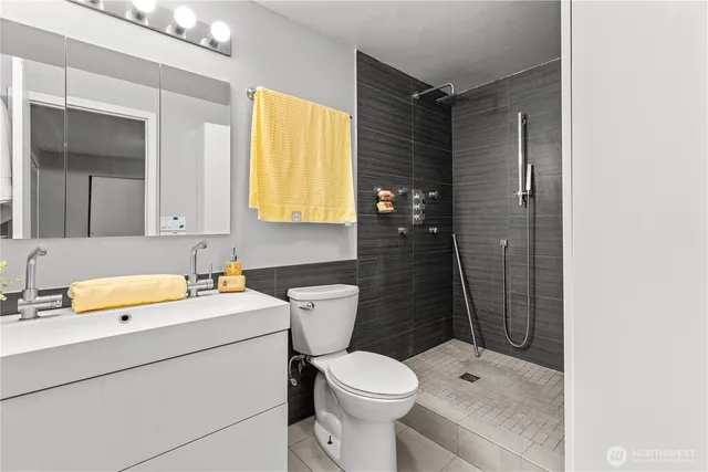 a bathroom with a sink toilet and shower